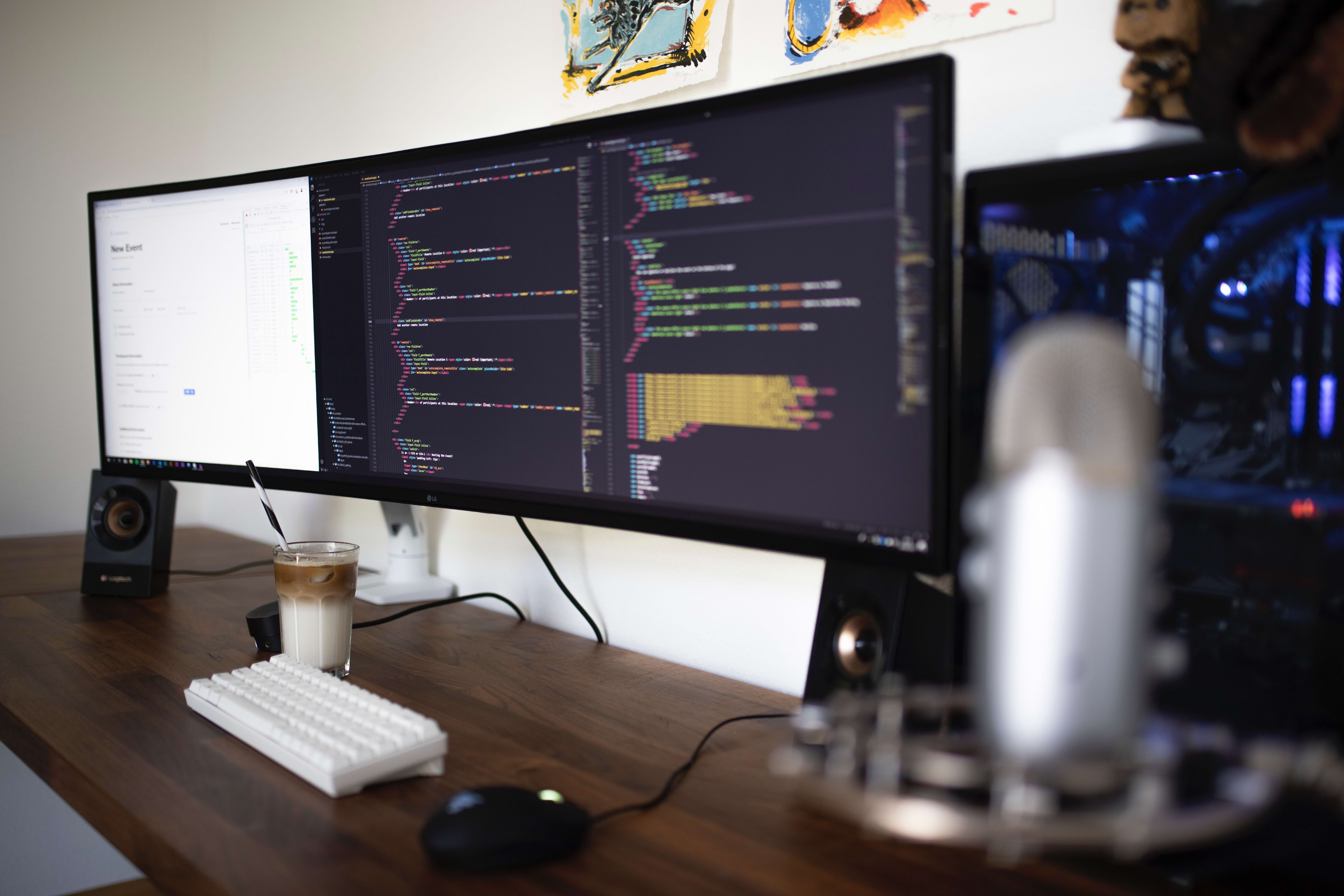 Home Office desk with software code on screen
