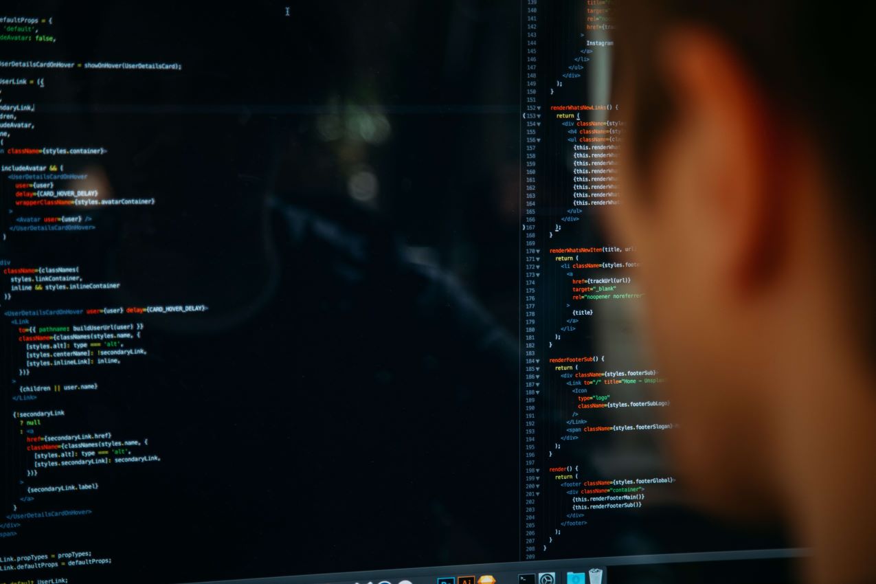 A blurred image of a man looking at software code